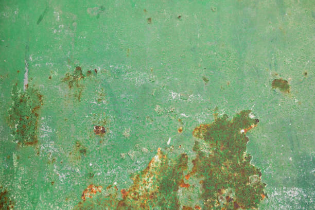 istock Multicolor background: rusty metal surface with green paint that cracks and cracks 1058132208