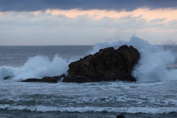 istock Wave Crashing against a Rock in the Pacific Ocean 1058132316