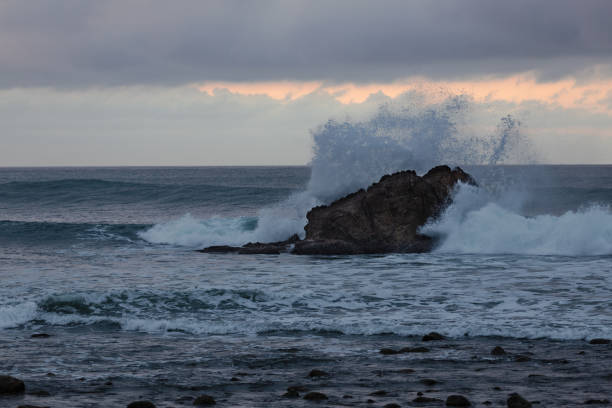 istock Wave Crashing against a Rock in the Pacific Ocean 1058132330