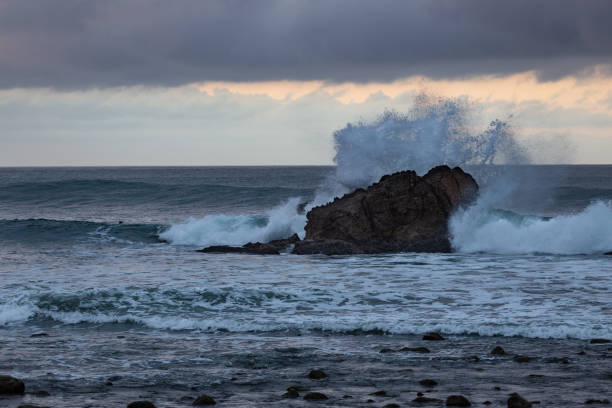 istock Wave Crashing against a Rock in the Pacific Ocean 1058132394