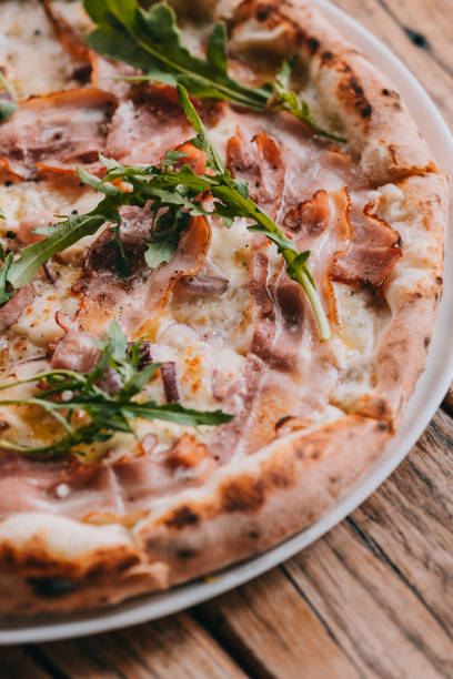 istock Pizza carbonara on rustic wooden table 1058133054