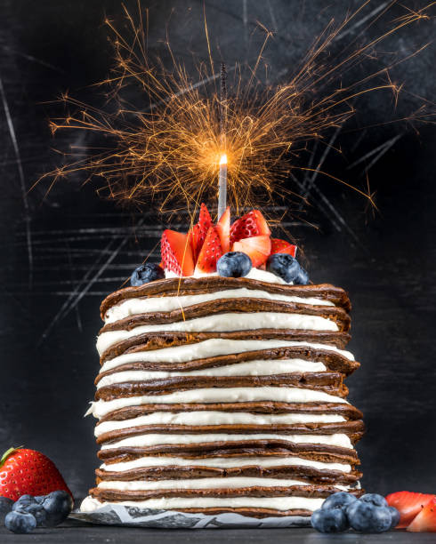 istock Pancake stack with sparkler, mascarpone cream, blueberries and strawberries 1058140262