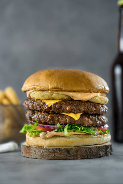 istock Double stacked cheeseburger with onion rings 1058140294