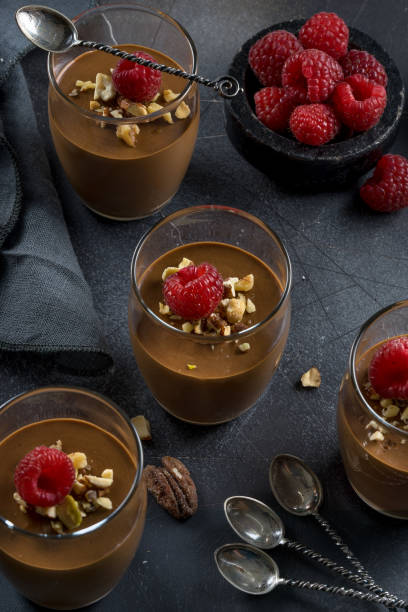istock Chocolate mousse with candied nuts and raspberries 1058140312