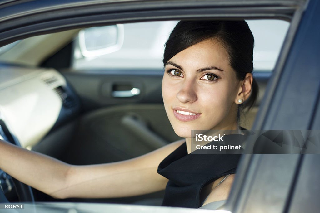 Happy woman drives her car  20-24 Years Stock Photo