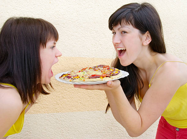 istock Two young woman eating 105814744