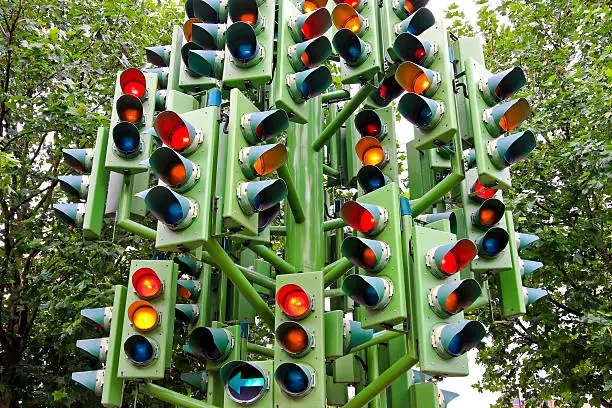Lot of traffic lights at big pole.