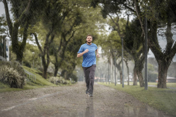 istock Man running in bad weather conditions 1058150044