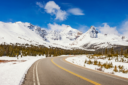 Stock photograph of the Icefields Parkway and the East face of Mount Athabasca in Alberta Canada on a sunny day.