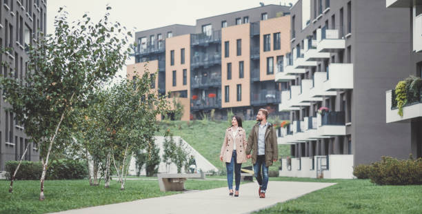 Young couple looking for apartment Young couple looking for apartment. Image taken at average residential area with multiple ownership block of flats type of buildings. tenant stock pictures, royalty-free photos & images