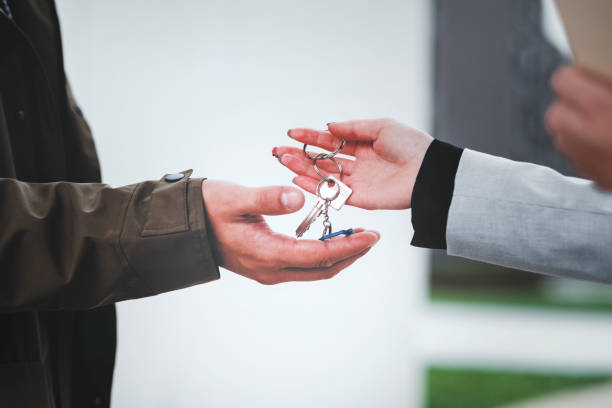 istock Real estate agent handing over home key 1058156438
