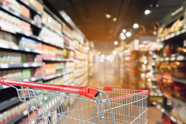istock supermarket aisle blurred background with empty red shopping cart 1058161164