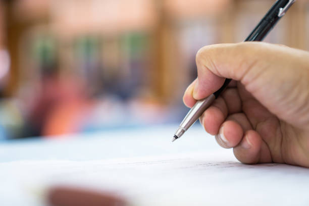istock Asian Business man Manager checking and signing applicant filling documents reports papers company application form or registering claim in meeting room office. Document Report business Concept 1058161496
