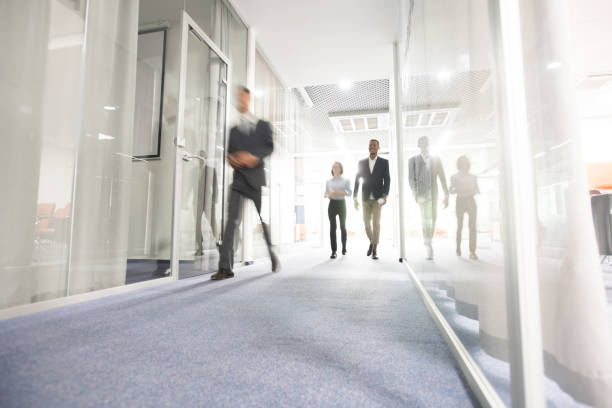 Business people walking in office corridor