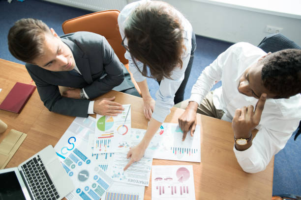 istock Business experts viewing papers at meeting 1058163424