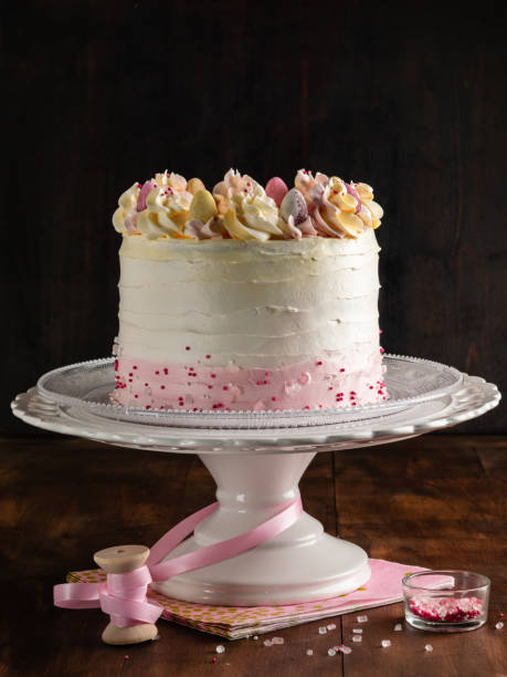 istock Birthday decorated cake with sprinkles on colorful background. Vertical. Celebration function. 1058165310