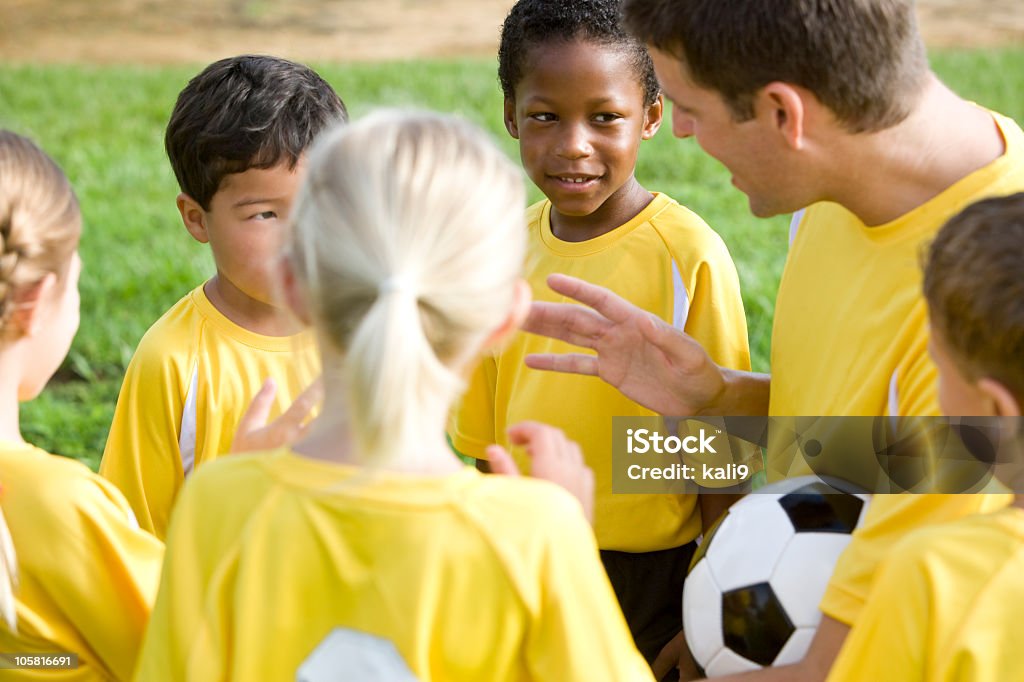 Coach with diverse young team of soccer players Portrait of coach with young team of soccer players Boys Stock Photo