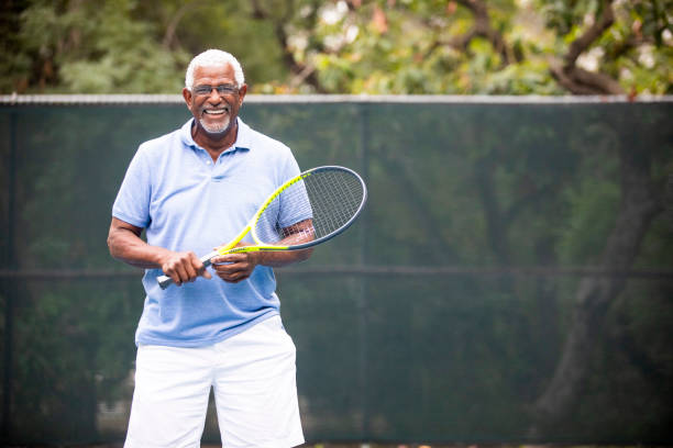 istock Senior Black Man Playing Tennis 1058168388