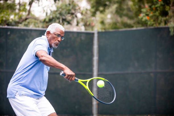 istock Senior Black Man Playing Tennis 1058168422