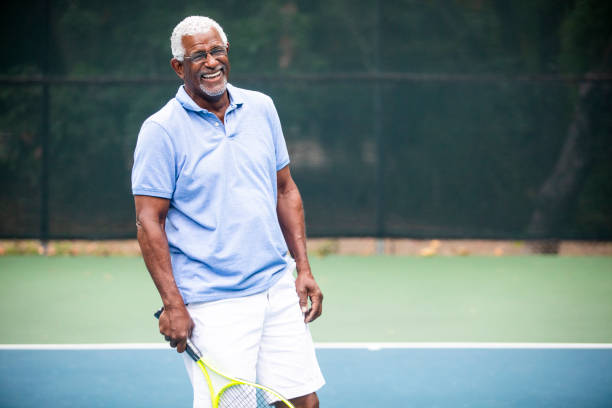 istock Senior Black Man Playing Tennis 1058168424