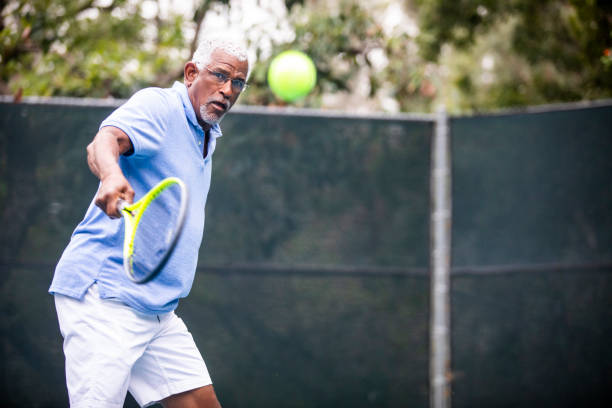 istock Senior Black Man Playing Tennis 1058168606