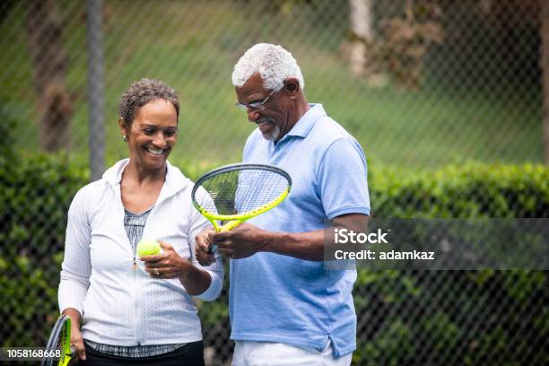 Senior Black Couple On Tennis Court Stock Photo - Download Image Now - Tennis, Playing, Senior Adult