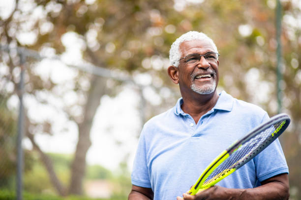 istock Senior Black Man Playing Tennis 1058168978