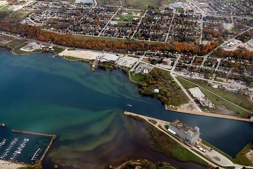 Aerial view from airplane of Owen Sound, Ontario grain elevators, bay and city with fall colors