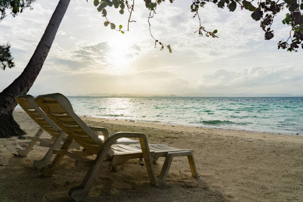 istock Two chair on sand beach in afternoon 1058178258