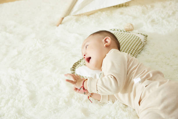 istock Cute little baby sleeping on bed at home 1058178550