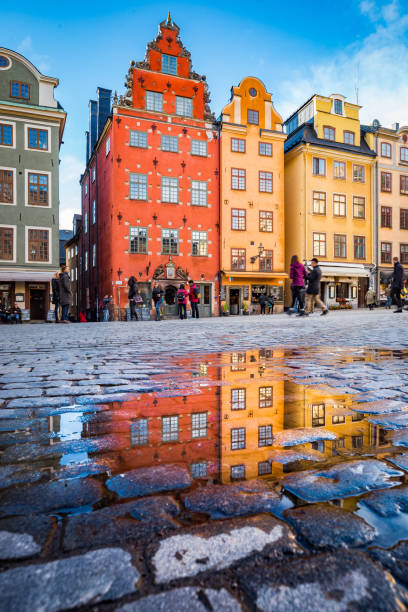 Gamla Stan, Stockholm, Sweden Classic view of colorful houses at famous Stortorget town square in Stockholm's historic Gamla Stan (Old Town) reflecting in a puddle, central Stockholm, Sweden stortorget photos stock pictures, royalty-free photos & images