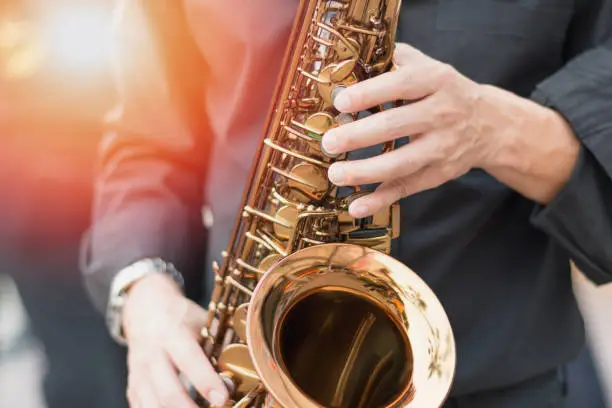 Photo of International jazz day and World Jazz festival. Saxophone, music instrument played by saxophonist player musician in fest.