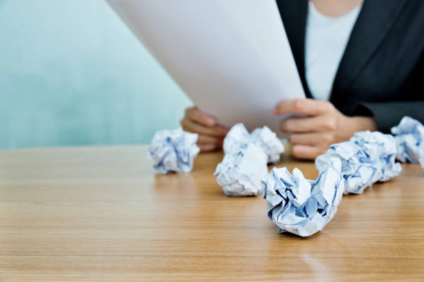 Crumpled paper balls on office desk.