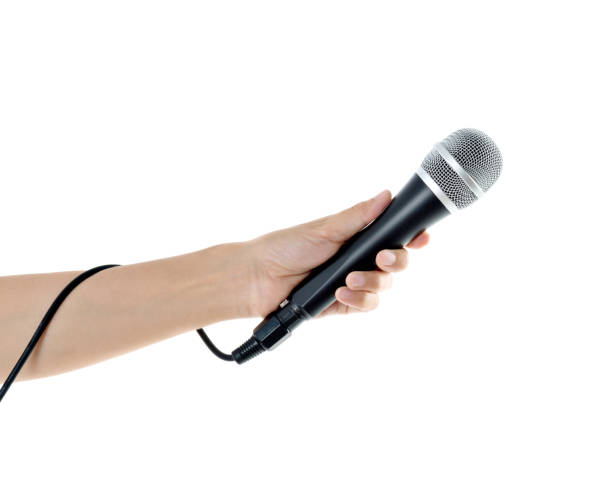 istock Woman hand holding a microphone on white background 1058186528