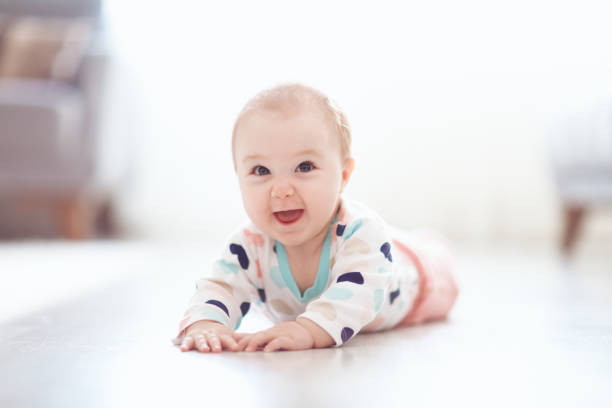 istock Baby rolling rolling around on the floor 1058186562