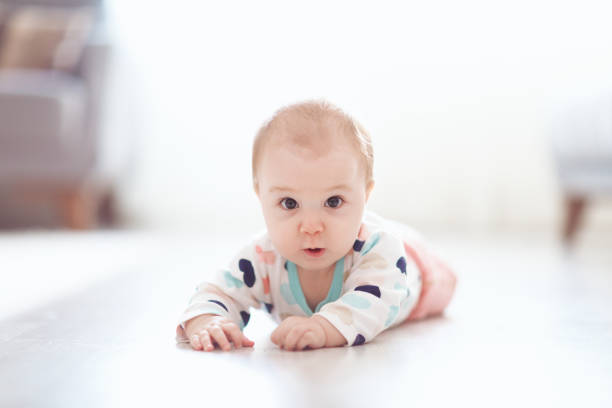 istock Baby rolling rolling around on the floor 1058187814