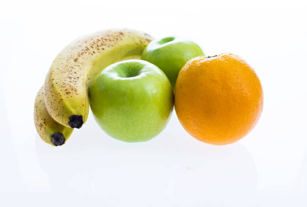 Orange, apples and bananas on white background.