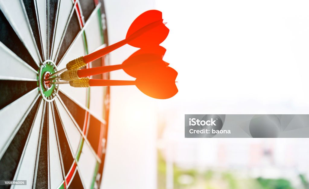 Dart board with three darts outdoors Dart board with three darts outdoors. Aspirations Stock Photo