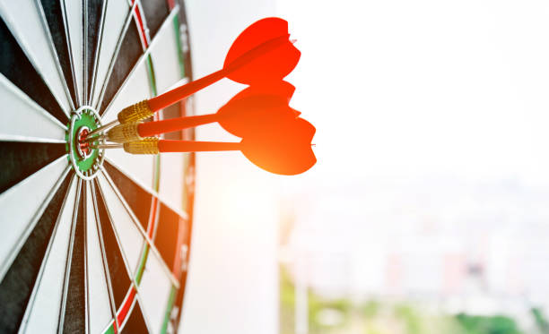 Dart board with three darts outdoors Dart board with three darts outdoors. dartboard photos stock pictures, royalty-free photos & images
