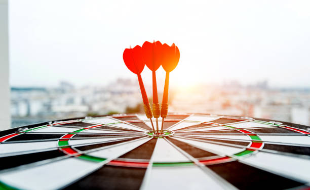 istock Dart board with three darts outdoors 1058196032