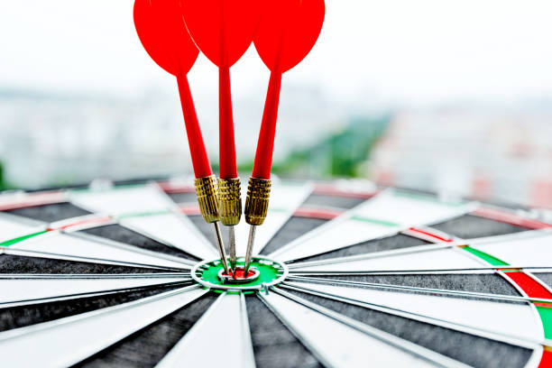 istock Dart board with three darts outdoors 1058196044