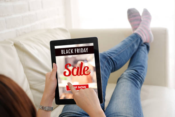 istock Woman hands using digital tablet with black friday sale web banner on screen background, Online shopping sale, business and technology 1058197620