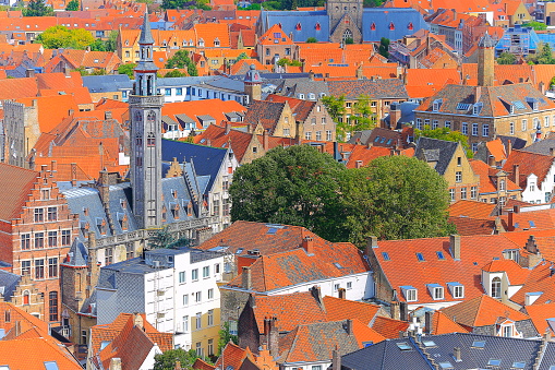 Above Bruges rooftops and gothic cathedral with bell tower - medieval old town - Belgium