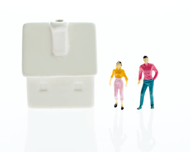 istock Couple figurine standing outside the house 1058199754