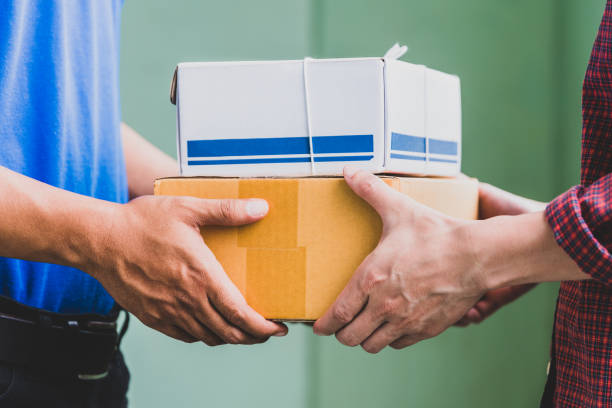 istock Male hand accepting a delivery of boxes from deliveryman. 1058203338