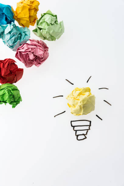 istock Yellow crumpled paper light bulb stand out 1058203374