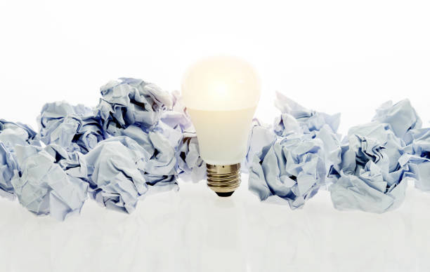 istock Light bulb and paper crumpled balls 1058203482