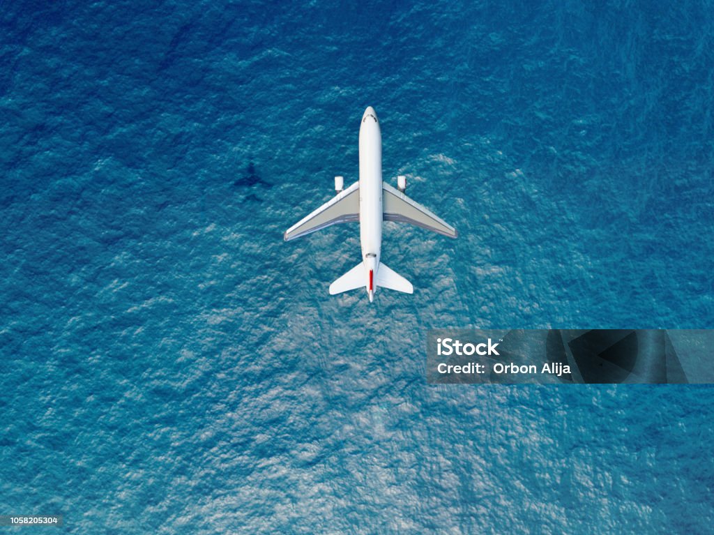 Airplane flies over a sea Airplane Stock Photo