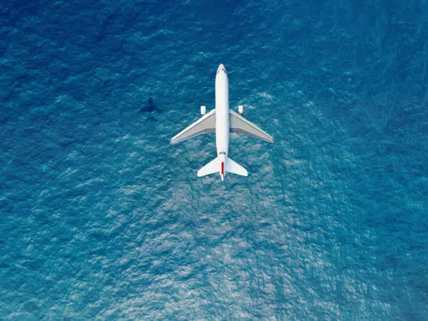 Photo of Airplane flies over a sea