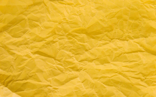 istock Texture of yellow crumpled paper 1058206378